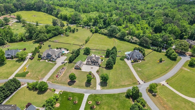 bird's eye view with a wooded view