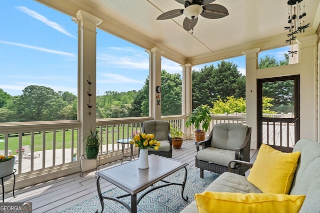 sunroom with a ceiling fan and outdoor lounge area