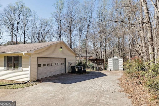 view of side of property featuring an outbuilding, a shed, roof with shingles, and a garage