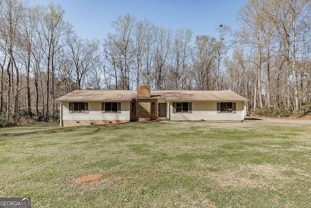 ranch-style home with a front lawn and a chimney
