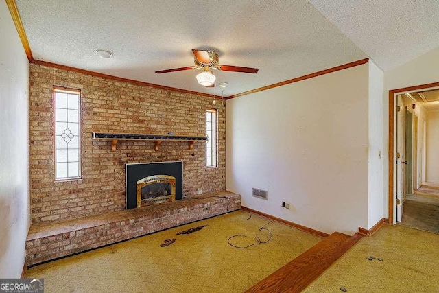 unfurnished living room featuring ceiling fan, a textured ceiling, a fireplace, tile patterned floors, and baseboards