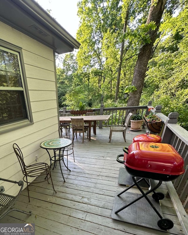 wooden deck with outdoor dining space