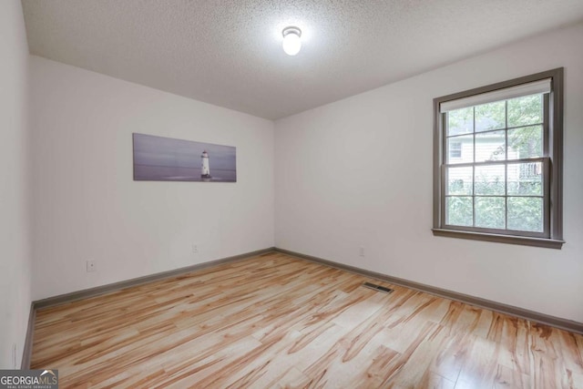 full bath with vanity, toilet, a textured ceiling, wood finished floors, and a shower with curtain