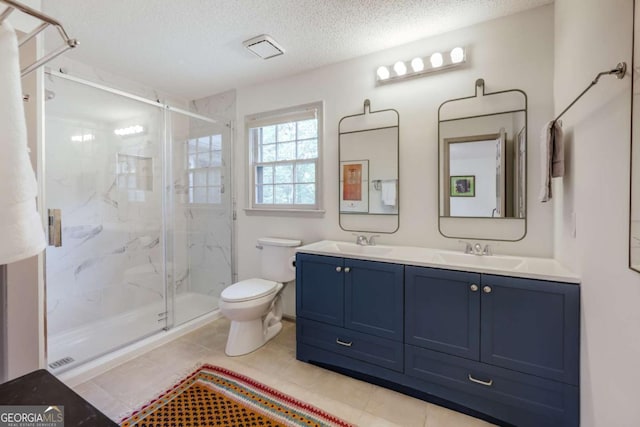 full bath featuring toilet, tile patterned floors, a marble finish shower, and vanity
