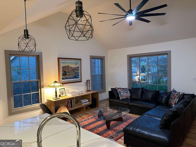living area featuring ceiling fan, wood finished floors, and high vaulted ceiling