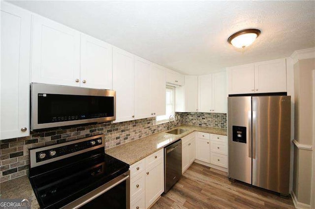 1616 W Kellogg Cir, Douglasville, GA 30134 - kitchen featuring a sink, white cabinetry, appliances with stainless steel finishes, and wood finished floors