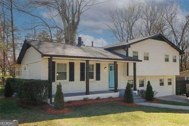 1616 W Kellogg Cir, Douglasville, GA 30134 - split level home with brick siding, a front yard, covered porch, and a chimney