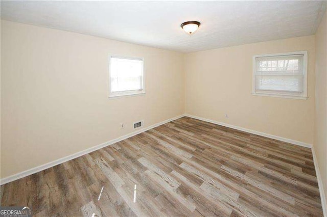 1616 W Kellogg Cir, Douglasville, GA 30134 - unfurnished room featuring baseboards, a healthy amount of sunlight, and wood finished floors