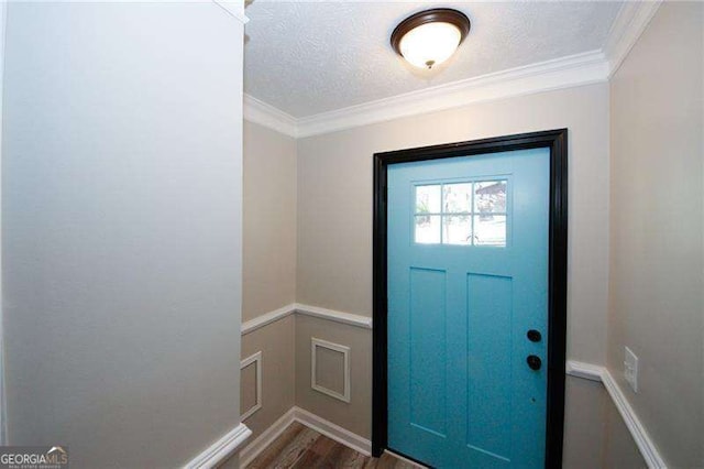 1616 W Kellogg Cir, Douglasville, GA 30134 - entrance foyer with crown molding, a textured ceiling, baseboards, and wood finished floors