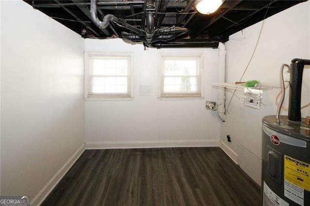 1616 W Kellogg Cir, Douglasville, GA 30134 - below grade area with water heater, baseboards, and dark wood-style flooring