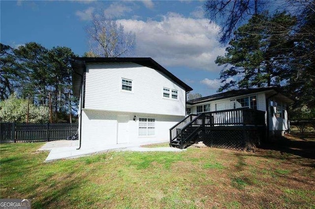 1616 W Kellogg Cir, Douglasville, GA 30134 - view of home's exterior featuring fence, a wooden deck, a lawn, and stairway