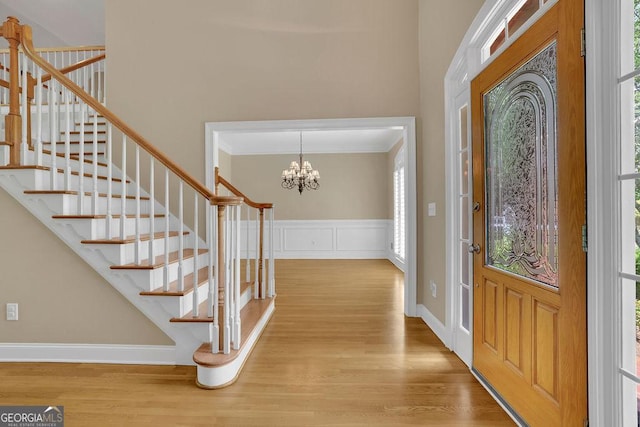 4810 Duncans Lake Dr, Buford, GA 30519 - entryway with healthy amount of natural light, wood finished floors, stairway, crown molding, and wainscoting