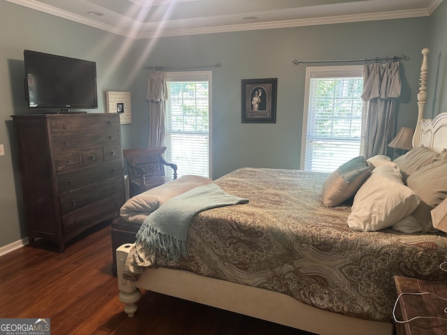 bedroom featuring ornamental molding, wood finished floors, and multiple windows