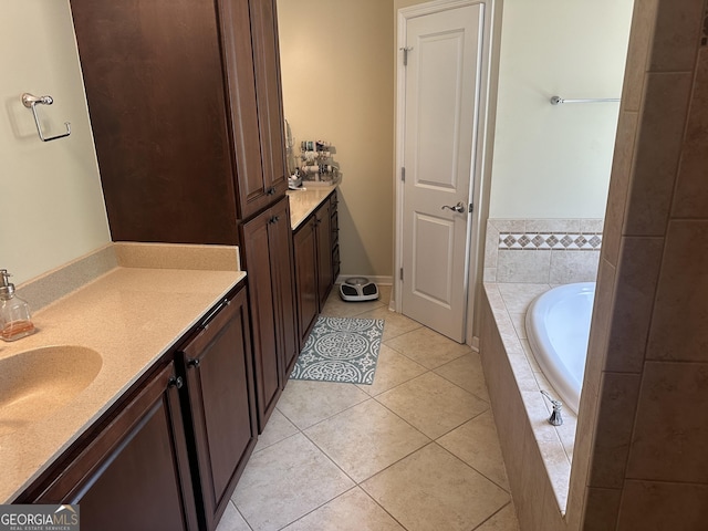 bathroom with vanity, tile patterned flooring, and a garden tub