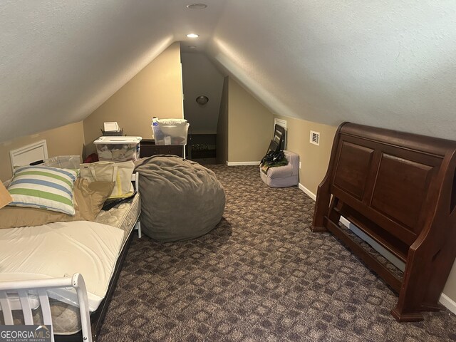 carpeted bedroom featuring baseboards, visible vents, and lofted ceiling