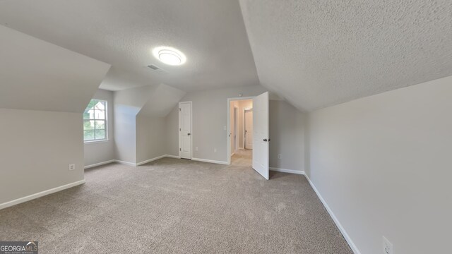 5326 Nader Pl, Stone Mountain, GA 30088 - bonus room featuring a textured ceiling, vaulted ceiling, and carpet
