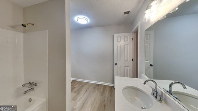 5326 Nader Pl, Stone Mountain, GA 30088 - full bath with visible vents, vanity, wood finished floors, baseboards, and shower / washtub combination