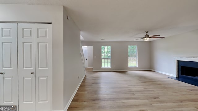 5326 Nader Pl, Stone Mountain, GA 30088 - unfurnished living room featuring baseboards, ceiling fan, wood finished floors, and a fireplace