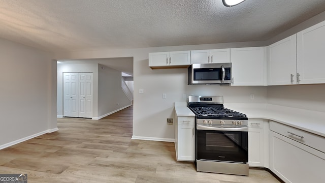 5326 Nader Pl, Stone Mountain, GA 30088 - kitchen featuring white cabinets, a textured ceiling, appliances with stainless steel finishes, and light countertops