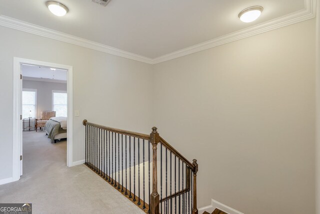 stairs with carpet flooring, baseboards, and ornamental molding