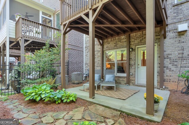 view of patio featuring a sunroom and cooling unit