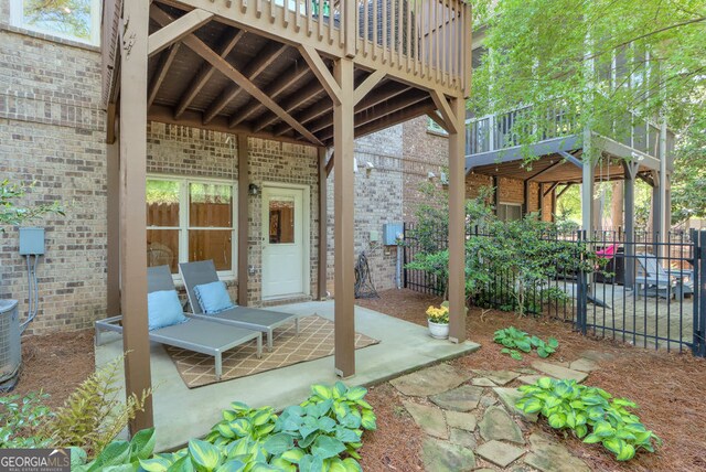 view of patio / terrace featuring fence and a wooden deck