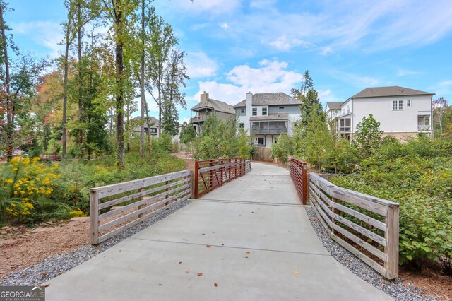 surrounding community with fence and a residential view