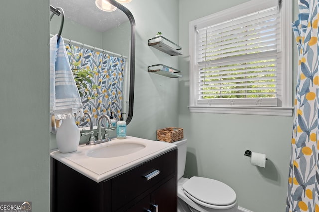 full bath with toilet and vanity