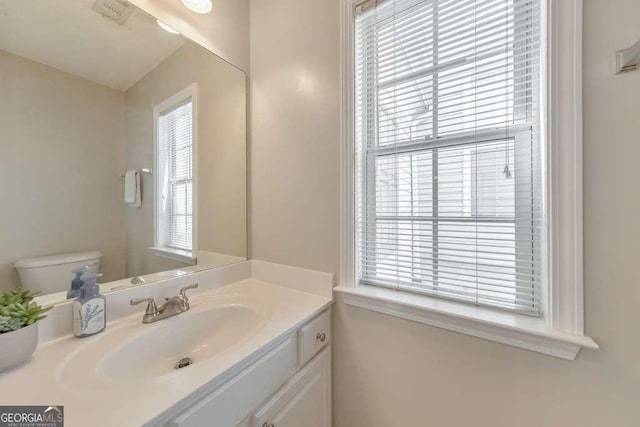 bathroom featuring toilet and vanity
