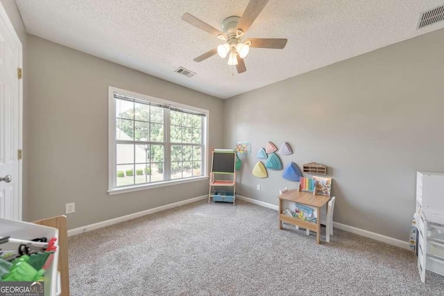 carpeted bedroom with a textured ceiling, visible vents, and baseboards