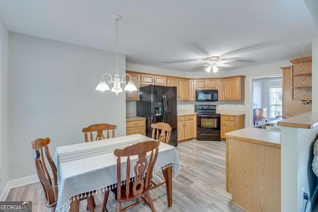 3238 Sharp Creek Ln, Buford, GA 30519 - kitchen featuring a sink, light countertops, black appliances, and light wood-style flooring