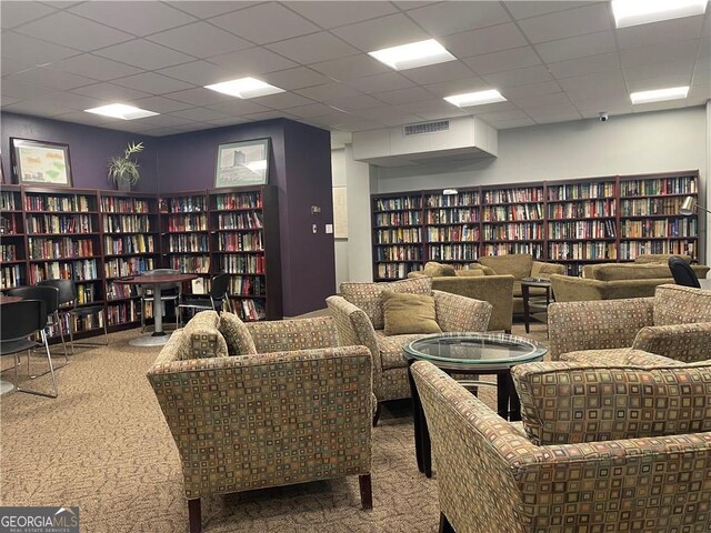 3060 Pharr Ct N Unit 607, Atlanta, GA 30305 - living area with a drop ceiling, wall of books, carpet flooring, and visible vents