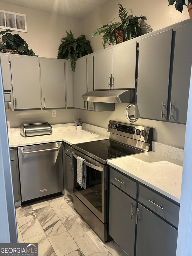 3060 Pharr Ct N Unit 607, Atlanta, GA 30305 - kitchen featuring light countertops, marble finish floor, stainless steel appliances, under cabinet range hood, and visible vents