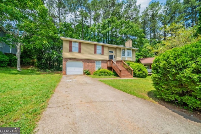 2132 Sara Ashley Way, Lithonia, GA 30058 - split foyer home with a chimney, driveway, a garage, a front yard, and brick siding