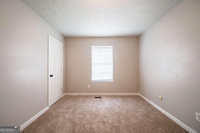 2132 Sara Ashley Way, Lithonia, GA 30058 - empty room with carpet floors, baseboards, and a textured ceiling