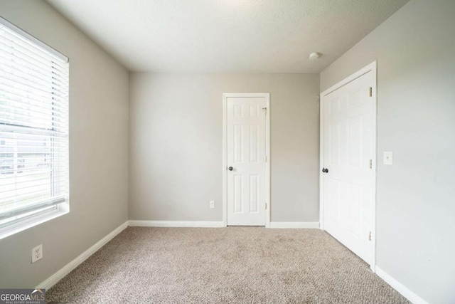 2132 Sara Ashley Way, Lithonia, GA 30058 - unfurnished bedroom with carpet floors and baseboards