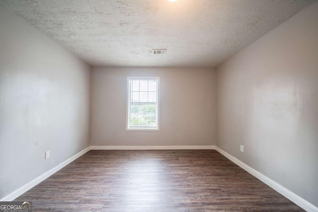2132 Sara Ashley Way, Lithonia, GA 30058 - unfurnished room with wood finished floors, a textured ceiling, and baseboards