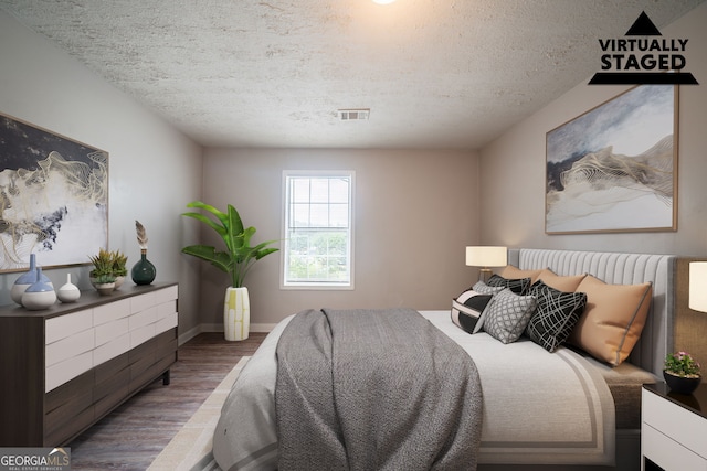 2132 Sara Ashley Way, Lithonia, GA 30058 - bedroom with wood finished floors, a textured ceiling, and baseboards