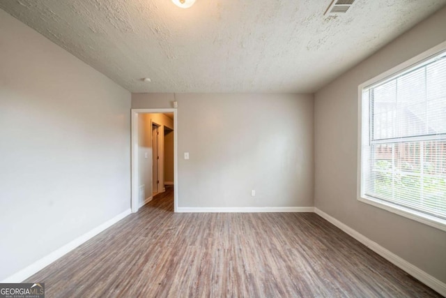 2132 Sara Ashley Way, Lithonia, GA 30058 - unfurnished room featuring wood finished floors, plenty of natural light, baseboards, and a textured ceiling