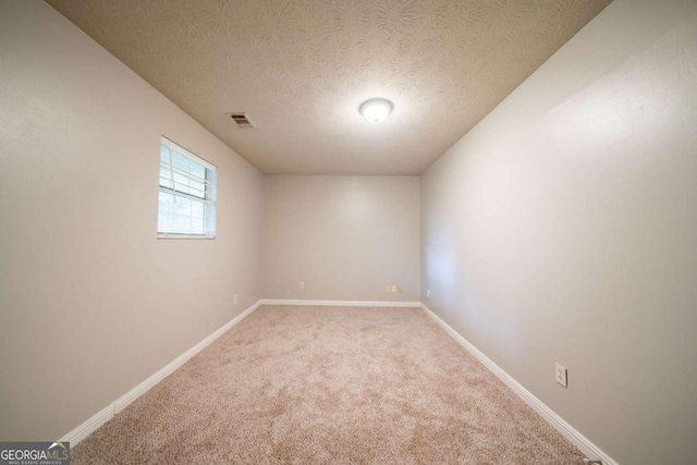 2132 Sara Ashley Way, Lithonia, GA 30058 - spare room with a textured ceiling, light colored carpet, and baseboards
