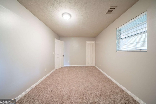 2132 Sara Ashley Way, Lithonia, GA 30058 - spare room with carpet flooring, a textured ceiling, and baseboards