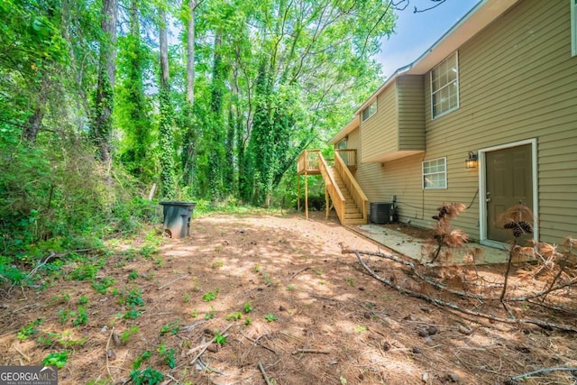 2132 Sara Ashley Way, Lithonia, GA 30058 - view of yard featuring stairway, central AC, and a wooden deck