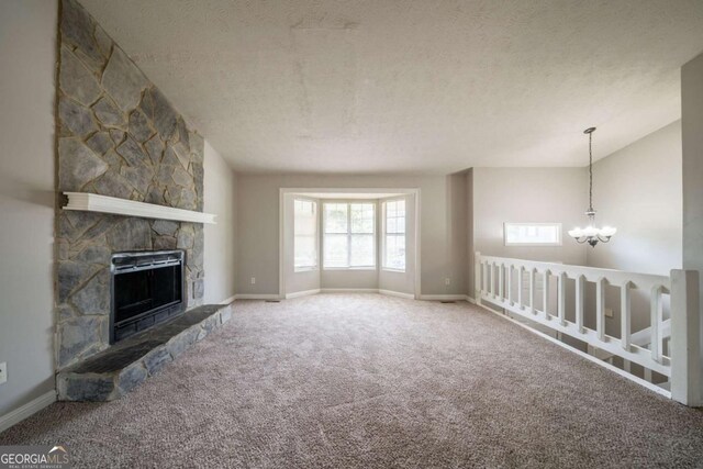 2132 Sara Ashley Way, Lithonia, GA 30058 - unfurnished living room featuring a chandelier, carpet flooring, vaulted ceiling, baseboards, and a textured ceiling