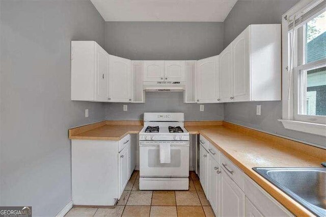 902 Allene Ave SW, Atlanta, GA 30310 - kitchen featuring a sink, under cabinet range hood, white range with gas stovetop, and white cabinetry