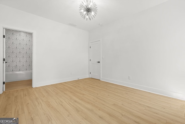 34 Candler Rd NE, Atlanta, GA 30317 - empty room with baseboards, an inviting chandelier, and light wood-type flooring