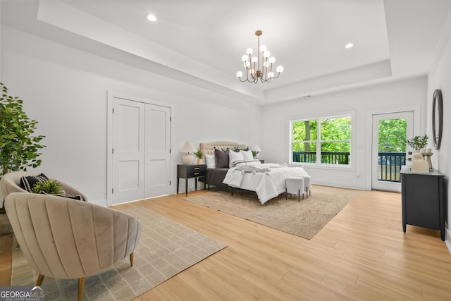 34 Candler Rd NE, Atlanta, GA 30317 - bedroom featuring wood finished floors, access to outside, recessed lighting, a raised ceiling, and a chandelier