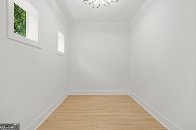 34 Candler Rd NE, Atlanta, GA 30317 - interior space with baseboards, a chandelier, a healthy amount of sunlight, and light wood-type flooring
