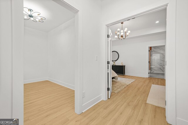 34 Candler Rd NE, Atlanta, GA 30317 - hallway with baseboards, wood finished floors, and a chandelier
