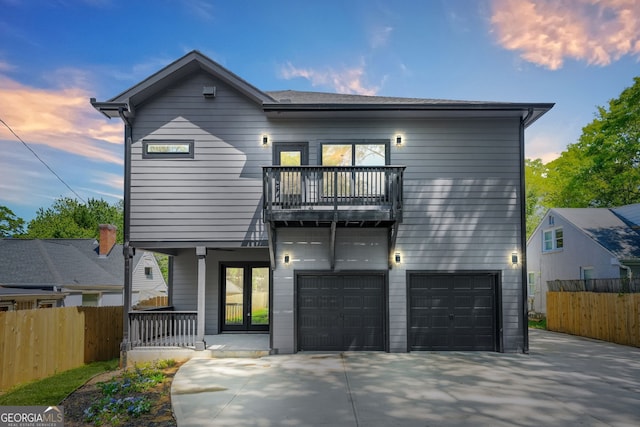 34 Candler Rd NE, Atlanta, GA 30317 - view of front of home featuring an attached garage, fence, a balcony, and concrete driveway