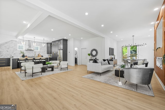 34 Candler Rd NE, Atlanta, GA 30317 - living room with light wood-style floors, a notable chandelier, and beamed ceiling
